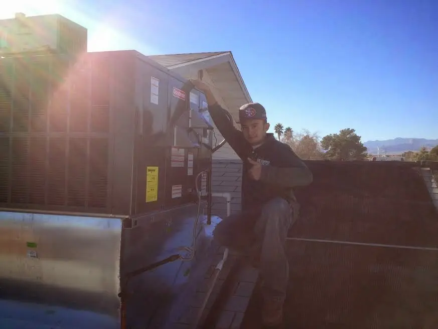 HVAC technician performing HVAC Inspection on a rooftop unit in Gladewater
